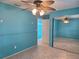 Bedroom showcases beautiful blue walls, neutral floors, and a large mirror door closet at 3357 Hunt Club Dr, Clearwater, FL 33761