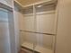 Walk-in closet features built-in shelving, drawers, and hanging rods for optimal organization at 3357 Hunt Club Dr, Clearwater, FL 33761