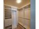 Walk-in closet features built-in shelving, drawers, and hanging rods for optimal organization at 3357 Hunt Club Dr, Clearwater, FL 33761