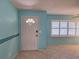 Inviting entryway featuring a white front door with half-moon window and bright, neutral tiling at 3357 Hunt Club Dr, Clearwater, FL 33761