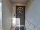 Inviting front door with decorative wreath, security features, and textured wall finish at 3357 Hunt Club Dr, Clearwater, FL 33761