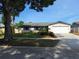 Charming single-story home featuring a well-maintained lawn, a two-car garage, and mature landscaping at 3357 Hunt Club Dr, Clearwater, FL 33761