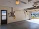 Clean garage with side door, hanging storage, epoxy floor, and electrical outlets at 3357 Hunt Club Dr, Clearwater, FL 33761