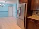 Modern refrigerator with water dispenser in a kitchen with granite countertops and blue walls at 3357 Hunt Club Dr, Clearwater, FL 33761
