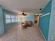 Bright living room featuring tile floors, a ceiling fan, and plenty of sunlight at 3357 Hunt Club Dr, Clearwater, FL 33761