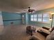Bright living room with tile floors, ceiling fan, and shuttered windows at 3357 Hunt Club Dr, Clearwater, FL 33761