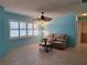 Cozy living room featuring a comfortable recliner, shuttered windows, and neutral tile floors at 3357 Hunt Club Dr, Clearwater, FL 33761