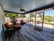 Enclosed patio with ceiling fan, wood-look tiled floors and plush seating with an outdoor view at 3357 Hunt Club Dr, Clearwater, FL 33761