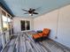 Relax in comfort on the screened patio with wood-look flooring and ceiling fan at 3357 Hunt Club Dr, Clearwater, FL 33761
