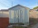 Exterior view of a well-maintained shed with double doors and fresh paint, providing ample storage space at 3357 Hunt Club Dr, Clearwater, FL 33761