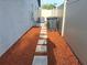 Functional side yard featuring stone pavers, mulch ground cover, utility access, and a privacy fence at 3357 Hunt Club Dr, Clearwater, FL 33761