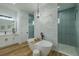Elegant primary bathroom featuring a freestanding tub, walk-in shower, and modern chandelier at 3515 Powerline Rd, Lithia, FL 33547