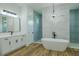 Bright bathroom with vanity, stand alone tub, and glass enclosed shower at 3515 Powerline Rd, Lithia, FL 33547
