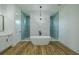 Modern bathroom featuring a standalone tub and glass-enclosed shower at 3515 Powerline Rd, Lithia, FL 33547
