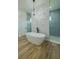 Elegant bathroom featuring a standalone tub, modern fixtures, and a stylish textured accent wall at 3515 Powerline Rd, Lithia, FL 33547