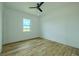 Bright bedroom features beautiful wood floors, one window, and a modern ceiling fan at 3515 Powerline Rd, Lithia, FL 33547