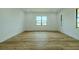 Spacious bedroom with ample natural light features beautiful wood floors and neutral walls at 3515 Powerline Rd, Lithia, FL 33547