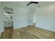 Bright bedroom shows ensuite bathroom, beautiful wood floors, and modern design at 3515 Powerline Rd, Lithia, FL 33547
