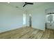 Bright bedroom shows ensuite bathroom, walk-in closet, beautiful wood floors, and modern ceiling fan at 3515 Powerline Rd, Lithia, FL 33547
