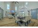 Open-concept dining area with a large table, chandelier, and a view of the brick fireplace at 3515 Powerline Rd, Lithia, FL 33547