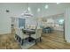 Open-concept dining area with views of the kitchen, island, and modern lighting at 3515 Powerline Rd, Lithia, FL 33547