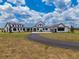 Stunning exterior showcasing a modern farmhouse design with a long drive and ample yard space at 3515 Powerline Rd, Lithia, FL 33547