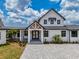 Front entrance with stone pavers, number signage, swing and covered entryway creating a welcoming feel at 3515 Powerline Rd, Lithia, FL 33547