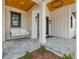 Charming front porch features a swing, wood ceiling, exterior lighting and grey paver flooring at 3515 Powerline Rd, Lithia, FL 33547