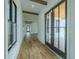 Inviting hallway with shiplap walls and access to the screened lanai at 3515 Powerline Rd, Lithia, FL 33547