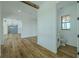 Hallway with wood floors, white shiplap walls, a beam ceiling, and access to a half-bathroom at 3515 Powerline Rd, Lithia, FL 33547