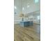 Open concept kitchen with large island, pendant lighting, and white cabinetry at 3515 Powerline Rd, Lithia, FL 33547