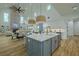 Bright kitchen featuring a large island with seating, pendant lighting, and open layout to dining and living areas at 3515 Powerline Rd, Lithia, FL 33547