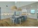 Bright and spacious kitchen featuring a large center island, stainless appliances, and designer lighting at 3515 Powerline Rd, Lithia, FL 33547