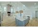 Modern kitchen and living space with open floor plan, brick fireplace, and stainless appliances at 3515 Powerline Rd, Lithia, FL 33547
