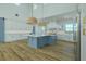 Modern kitchen with a center island, custom cabinets, and stainless steel appliances under a high ceiling at 3515 Powerline Rd, Lithia, FL 33547