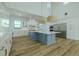A bright kitchen featuring stainless steel appliances, a stylish island, and ample counter space at 3515 Powerline Rd, Lithia, FL 33547