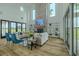 Bright living room featuring a brick fireplace, built-in shelving, and large windows at 3515 Powerline Rd, Lithia, FL 33547