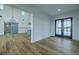 Bright, open-concept living room with modern chandelier and views to the kitchen, featuring wide plank flooring at 3515 Powerline Rd, Lithia, FL 33547