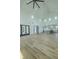 Open concept living room with high vaulted ceilings, kitchen, and natural light from many windows at 3515 Powerline Rd, Lithia, FL 33547