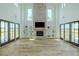 Open living room featuring a brick fireplace, a wall of built-ins and French doors to the outdoors at 3515 Powerline Rd, Lithia, FL 33547