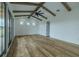 Bright living area features vaulted ceiling, wooden beams, and large windows at 3515 Powerline Rd, Lithia, FL 33547