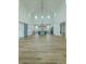 Bright open living space with vaulted ceilings, modern chandelier, and open concept floor plan at 3515 Powerline Rd, Lithia, FL 33547