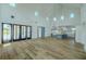 Spacious open-concept living area with kitchen, featuring high ceilings and elegant chandelier lighting at 3515 Powerline Rd, Lithia, FL 33547