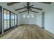 Vaulted ceiling and wooden beams accentuate the airy living room, which opens to the outdoors at 3515 Powerline Rd, Lithia, FL 33547