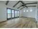 Large living room with beamed vaulted ceiling and shiplap accents provides ample natural light at 3515 Powerline Rd, Lithia, FL 33547