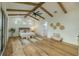 Spacious primary bedroom boasts vaulted ceilings with wood beams, large windows, and stylish decor at 3515 Powerline Rd, Lithia, FL 33547