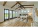 Bright primary bedroom with vaulted ceilings, wood beams, an exterior view, and tasteful decorations at 3515 Powerline Rd, Lithia, FL 33547