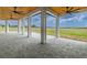 Covered outdoor patio with scenic views, perfect for enjoying nature, featuring white columns and wood ceiling at 3515 Powerline Rd, Lithia, FL 33547