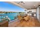 Balcony featuring a table with chairs and water views, along with a built-in outdoor kitchen at 3805 Gulf Blvd # 504, St Pete Beach, FL 33706
