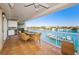 Balcony featuring a table with chairs and water views, along with a built-in outdoor kitchen at 3805 Gulf Blvd # 504, St Pete Beach, FL 33706